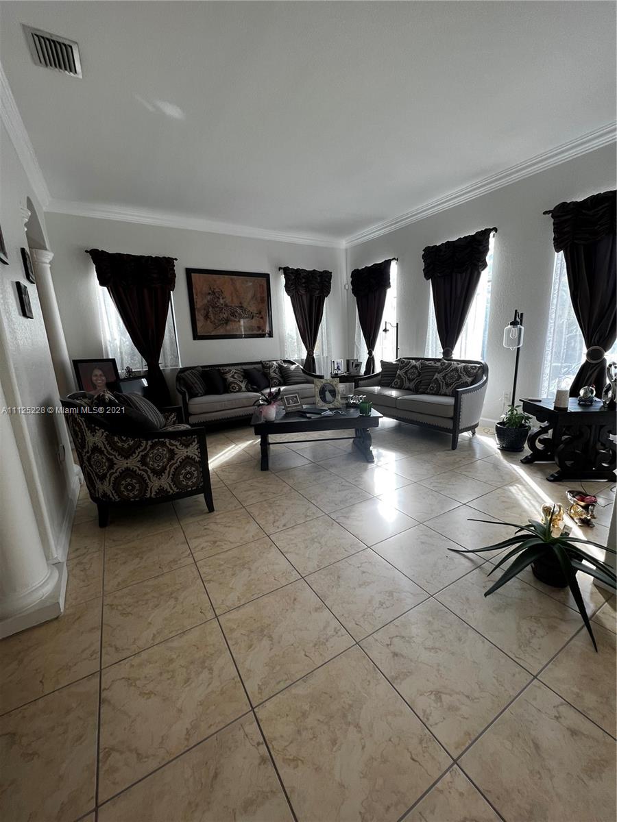 7985 Southwest 195th Street Cutler Bay, FL 33157 - Photo 9 of 16 a room with gym equipment and a flat screen tv