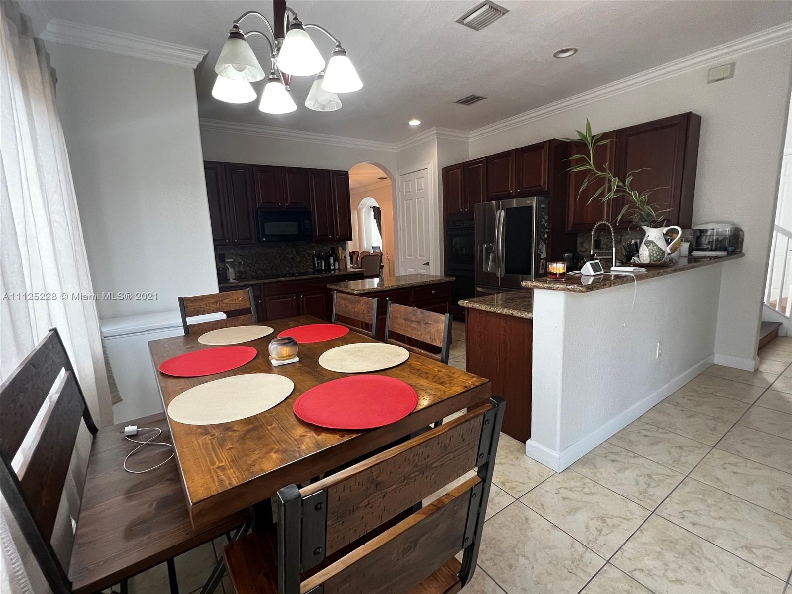 7985 Southwest 195th Street Cutler Bay, FL 33157 - Photo 10 of 16 a view of a dining room with furniture