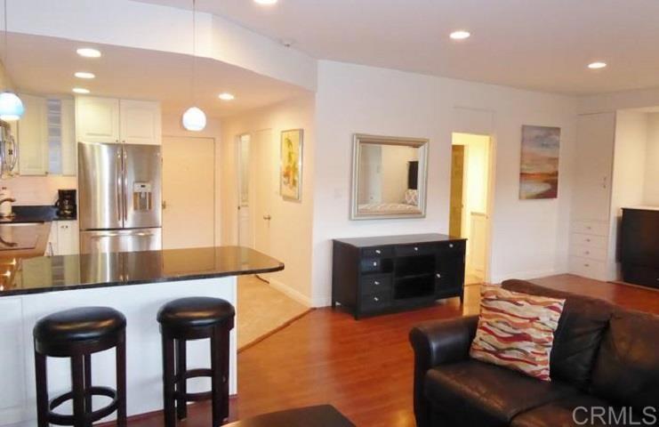 2005 Costa Del Mar Road, Unit 624 Carlsbad, CA 92009 - Photo 11 of 24 a living room with furniture and a wooden floor