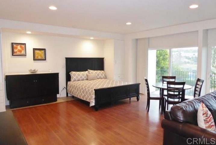 2005 Costa Del Mar Road, Unit 624 Carlsbad, CA 92009 - Photo 18 of 24 a spacious bedroom with a bed and a table in it