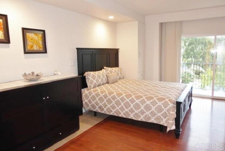 2005 Costa Del Mar Road, Unit 624 Carlsbad, CA 92009 - Photo 19 of 24 a bedroom with a bed and wooden floor