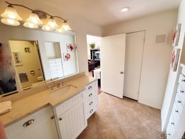 a spacious bathroom with a double vanity sink mirror and shower