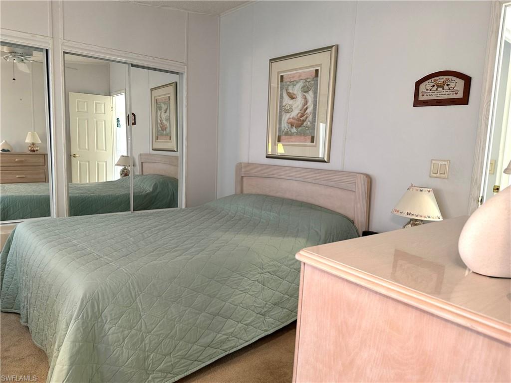 4680 Slash Pine Way West Estero, FL 33928 - Photo 12 of 20 a bedroom with a bed and a table