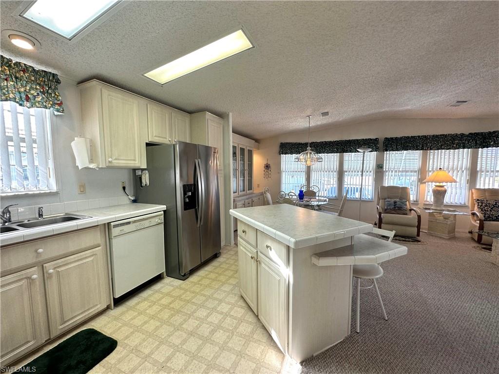 4680 Slash Pine Way West Estero, FL 33928 - Photo 4 of 20 a kitchen with sink cabinets and refrigerator