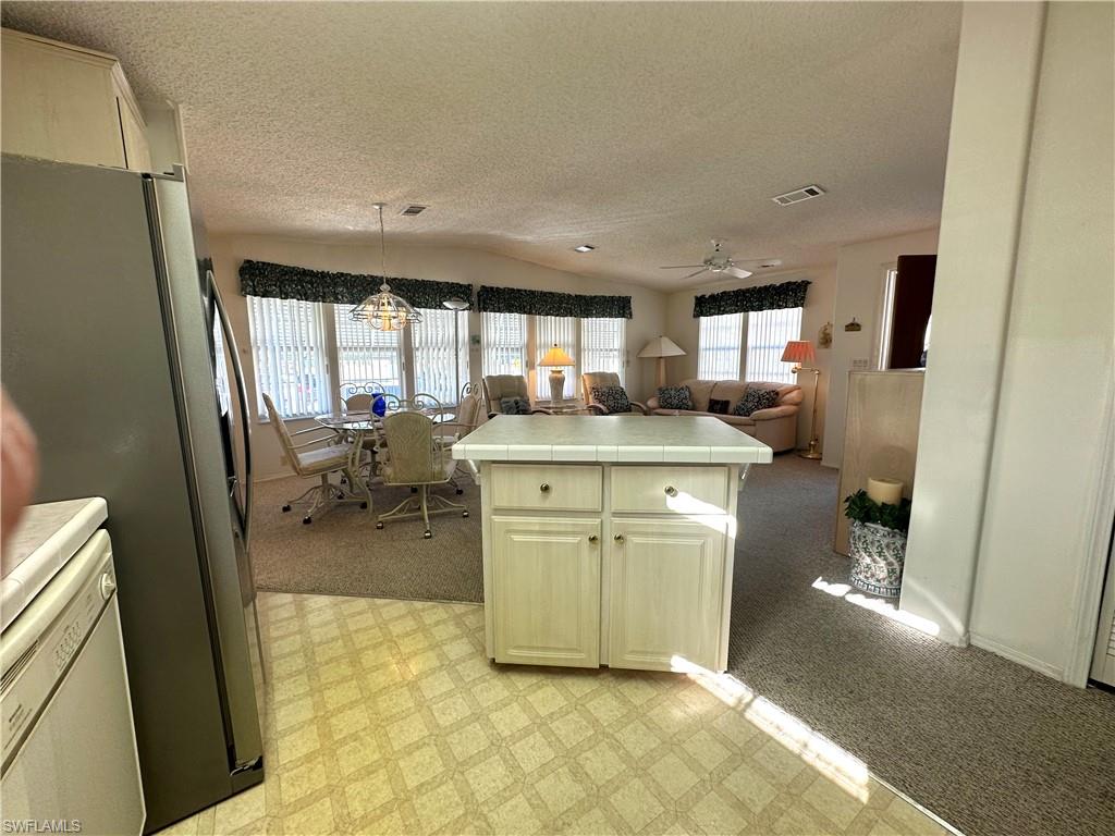 4680 Slash Pine Way West Estero, FL 33928 - Photo 9 of 20 a bathroom with a granite countertop sink a mirror and a bathtub