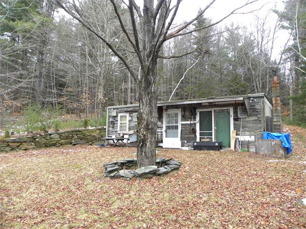 0 Sumner Stetson Road Colrain, MA 01340 - Photo 1 of 13 a front view of a house with a yard and outdoor seating