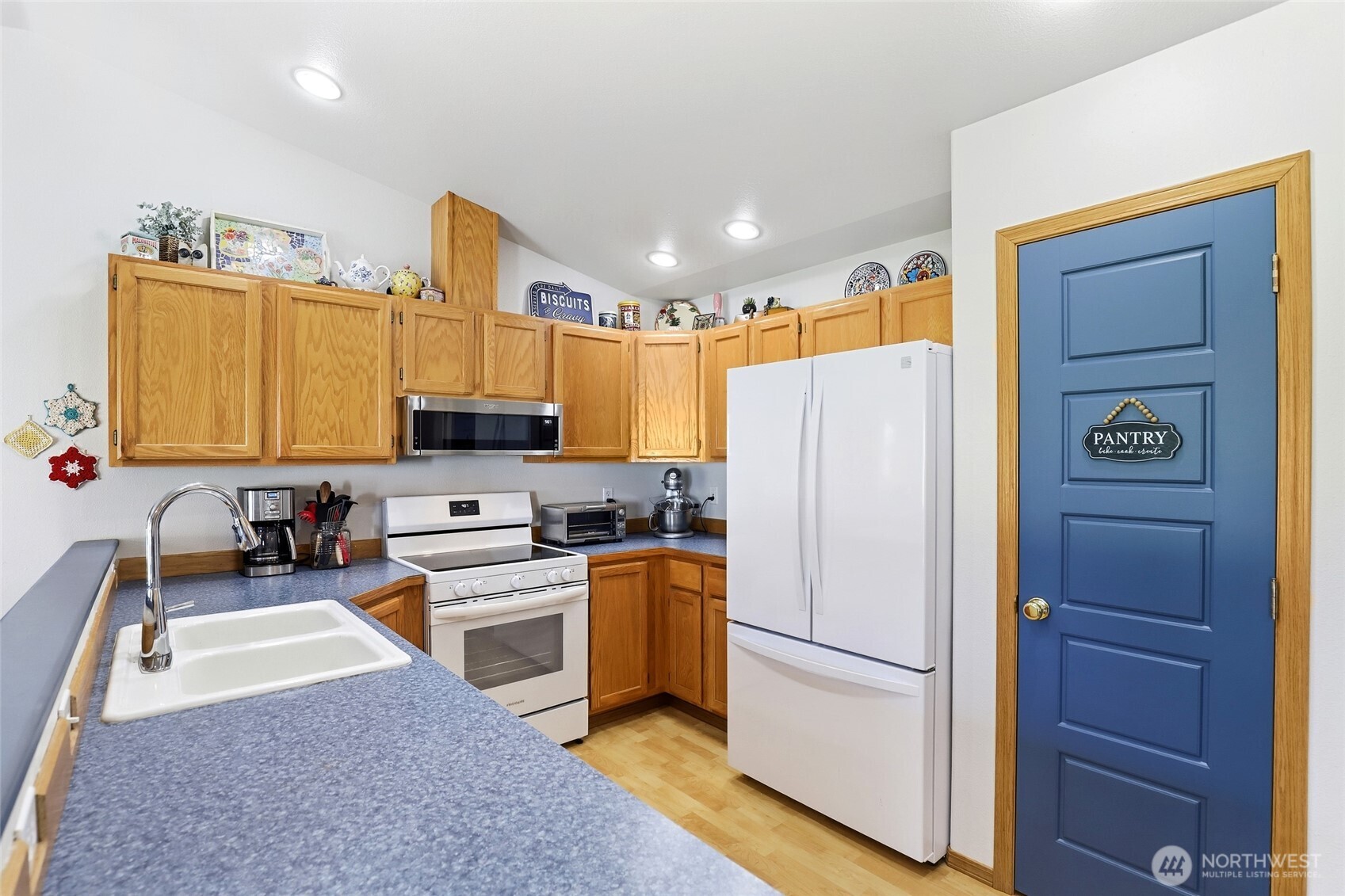 8008 188th Avenue Southwest Rochester, WA 98579 - Photo 18 of 40 a kitchen with a refrigerator a stove top oven a sink and dishwasher