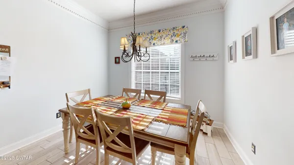a view of a dining room with furniture and chandelier