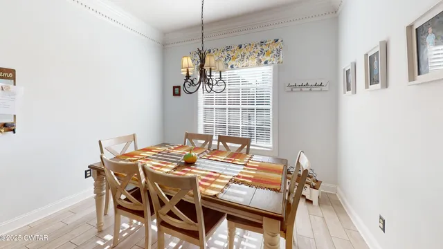 a view of a dining room with furniture and chandelier