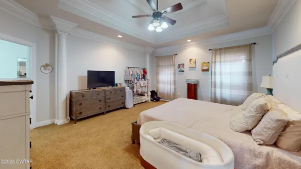 a bedroom with bed and a chandelier