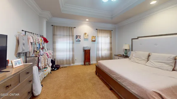a spacious bedroom with a bed and a walk in closet