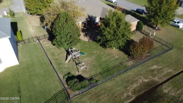 an aerial view of a house with a yard