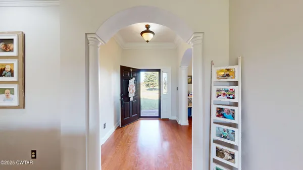 a view of an entryway with wooden floor