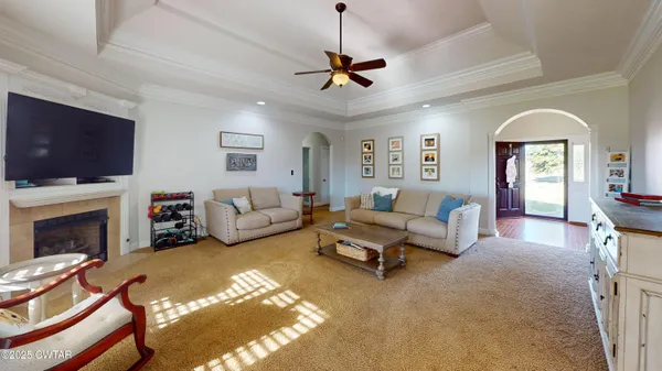 a living room with furniture fireplace and a flat screen tv