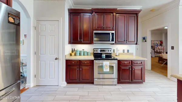 a kitchen with stainless steel appliances granite countertop a refrigerator and a stove top oven
