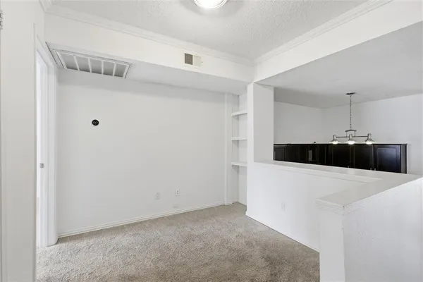 a view of kitchen and refrigerator