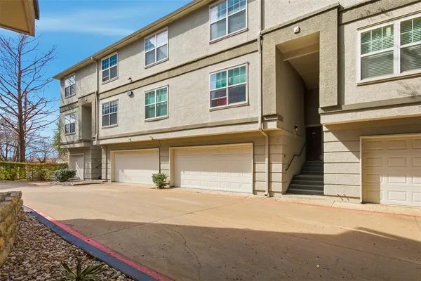 a street sign on a sidewalk next to a road
