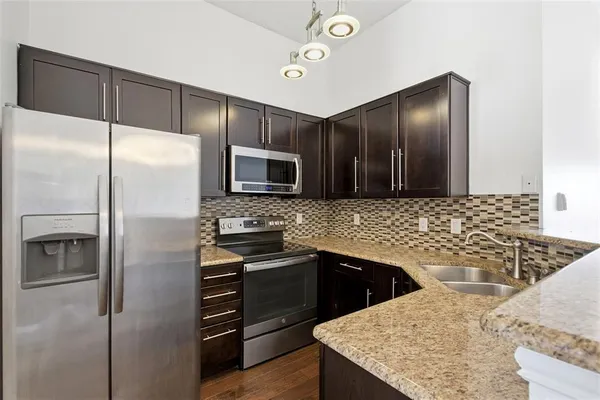 a kitchen with a refrigerator and a sink