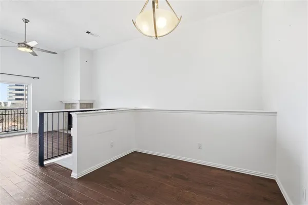 a view of a room with wooden floor and white walls