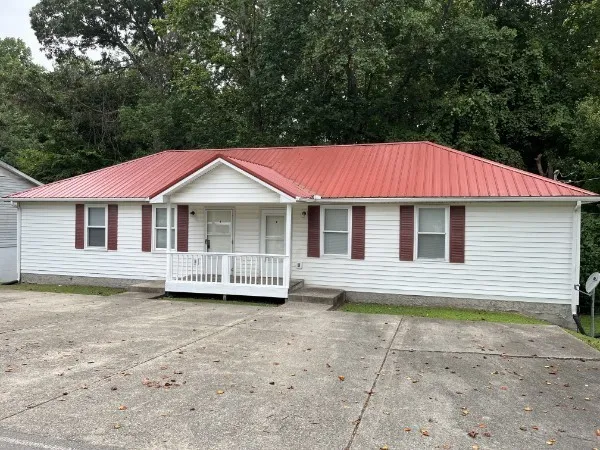 a front view of a house with a garden and porch