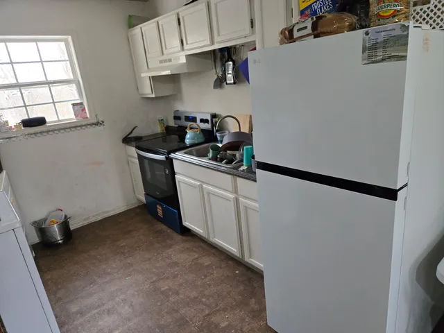 a kitchen with stainless steel appliances a stove and a refrigerator