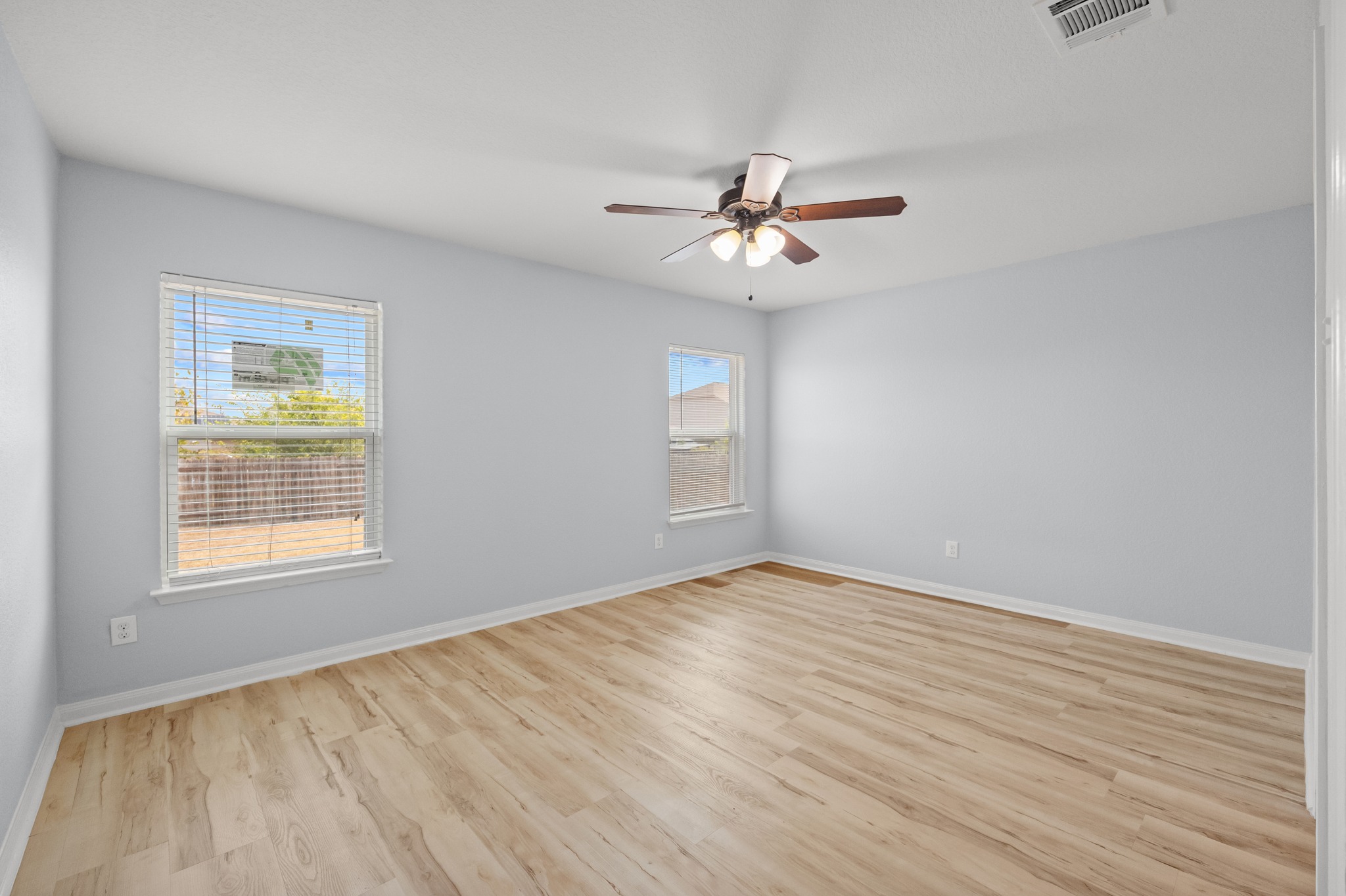 228 Millers Loop Jarrell, TX 76537 - Photo 11 of 26 Gleaming wood flooring complements the neutral walls and dual windows of this spacious room.