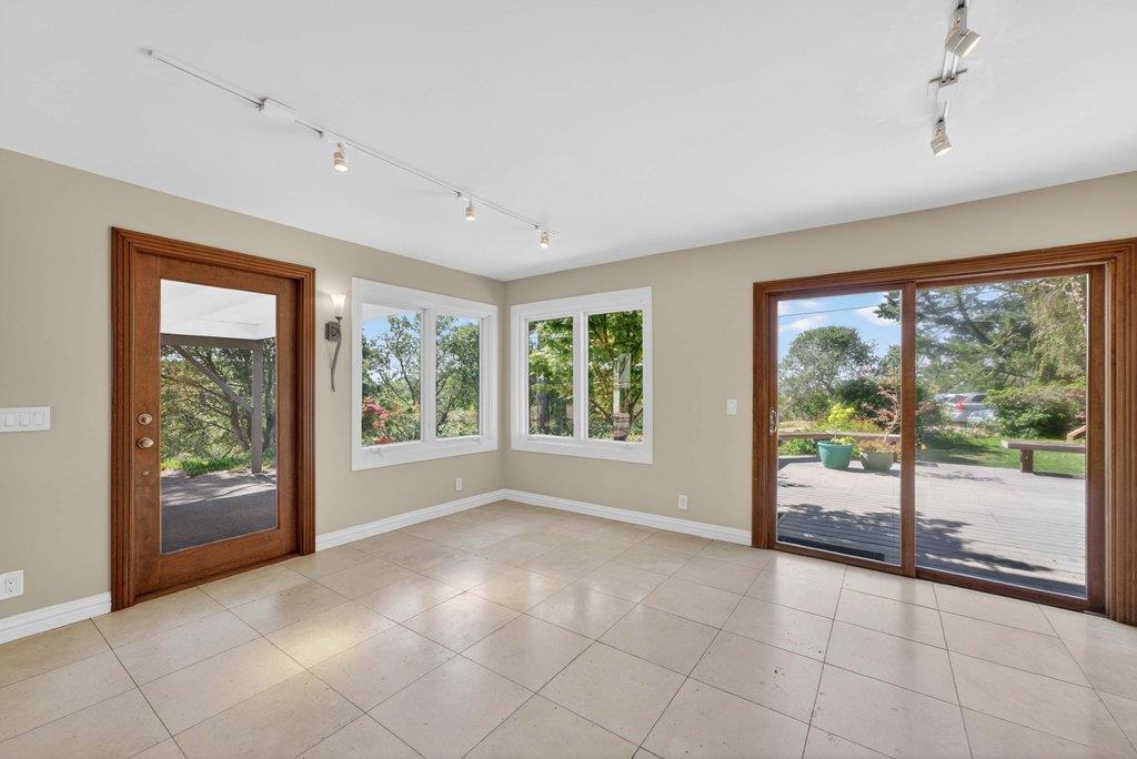 505 Hidden Valley Road Watsonville, CA 95076 - Photo 17 of 72 a view of an empty room with wooden floor and a window