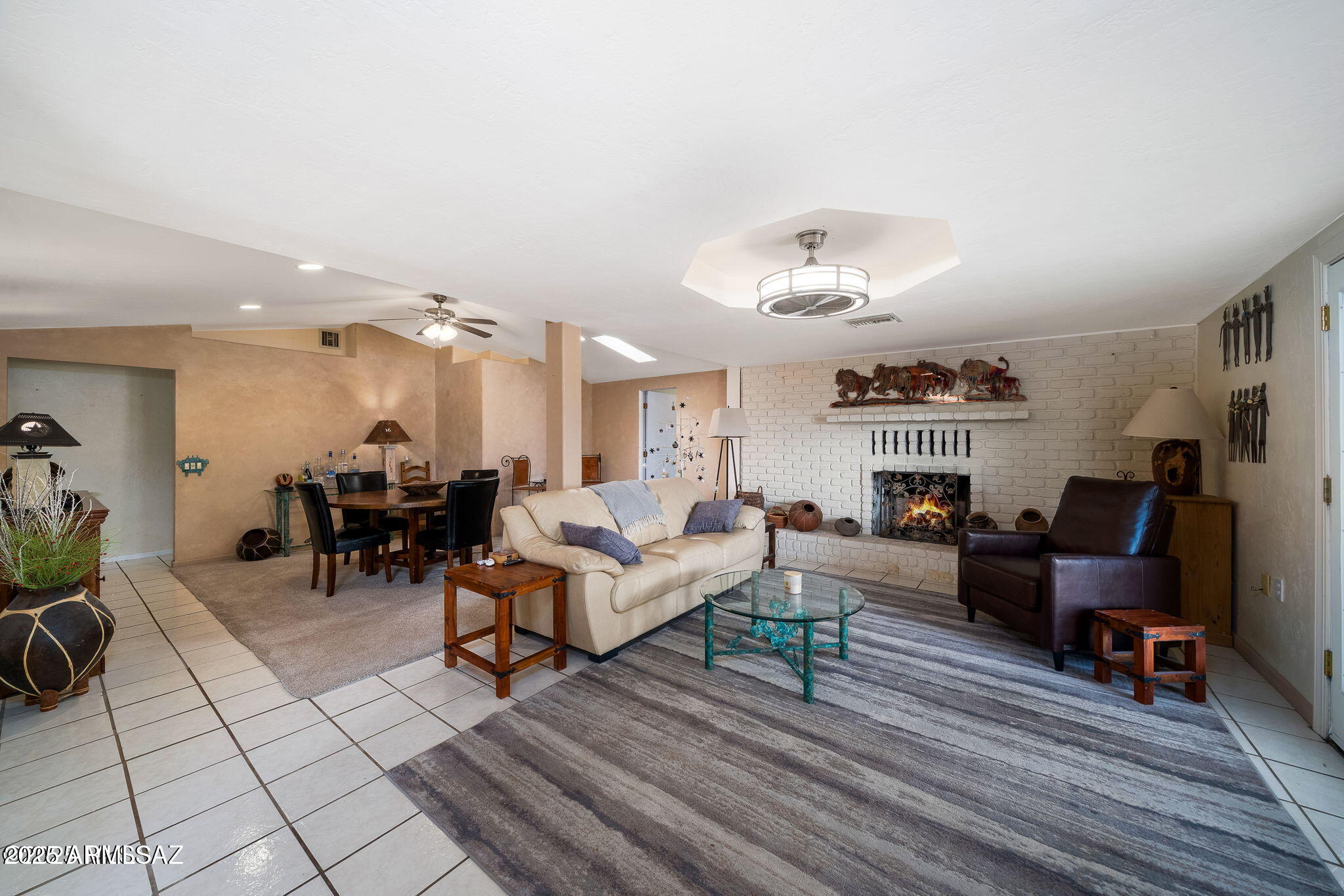 2350 West Sunkist Road Tucson, AZ 85755 - Photo 13 of 39 a living room with furniture and a dining table with wooden floor