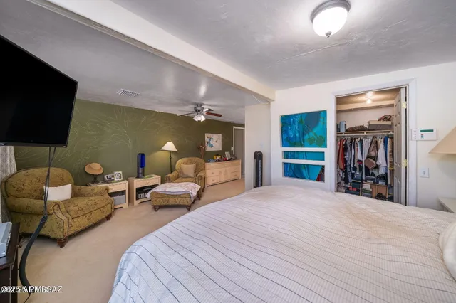 a bedroom with furniture and a flat screen tv