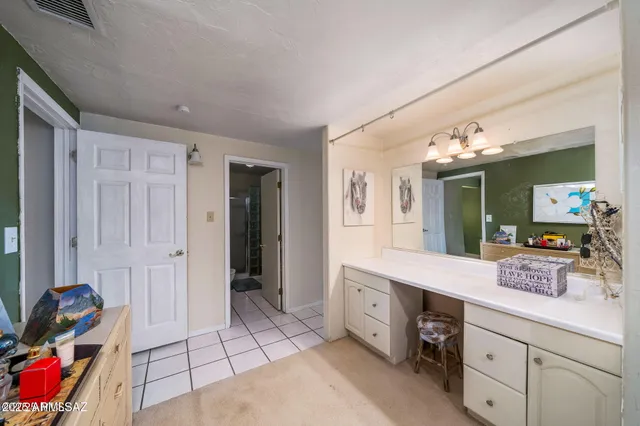 a spacious bathroom with a granite countertop sink a mirror and shower