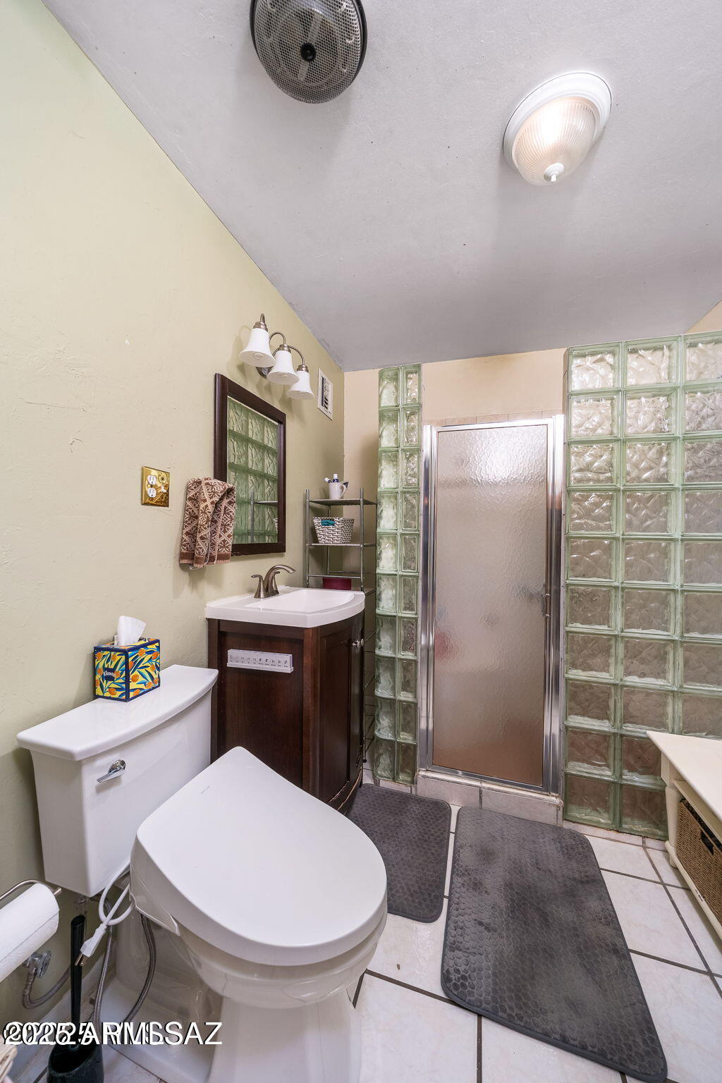 2350 West Sunkist Road Tucson, AZ 85755 - Photo 20 of 39 a bathroom with a toilet a sink and mirror