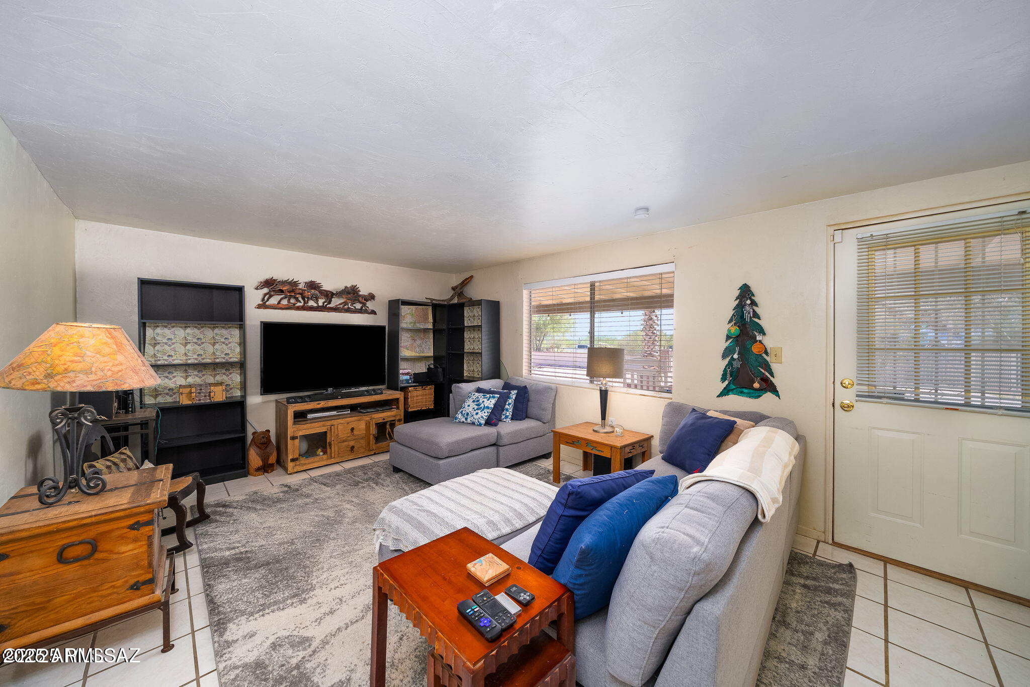 2350 West Sunkist Road Tucson, AZ 85755 - Photo 25 of 39 a living room with furniture and a flat screen tv