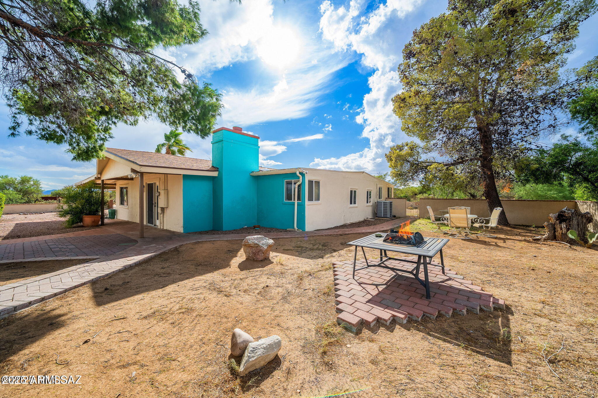 2350 West Sunkist Road Tucson, AZ 85755 - Photo 26 of 39 a front view of a house with a yard and sitting area