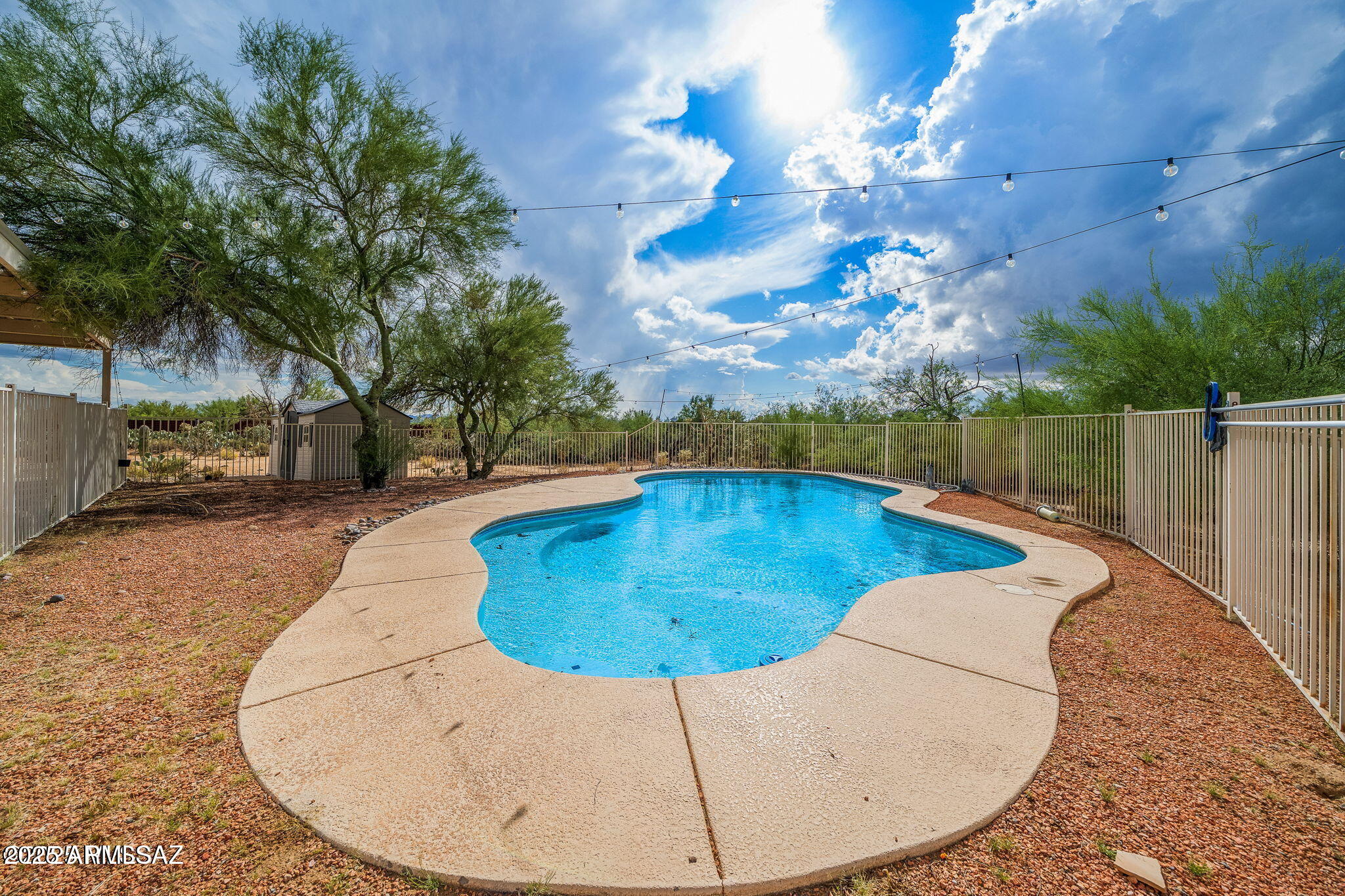 2350 West Sunkist Road Tucson, AZ 85755 - Photo 28 of 39 a view of a swimming pool with a patio