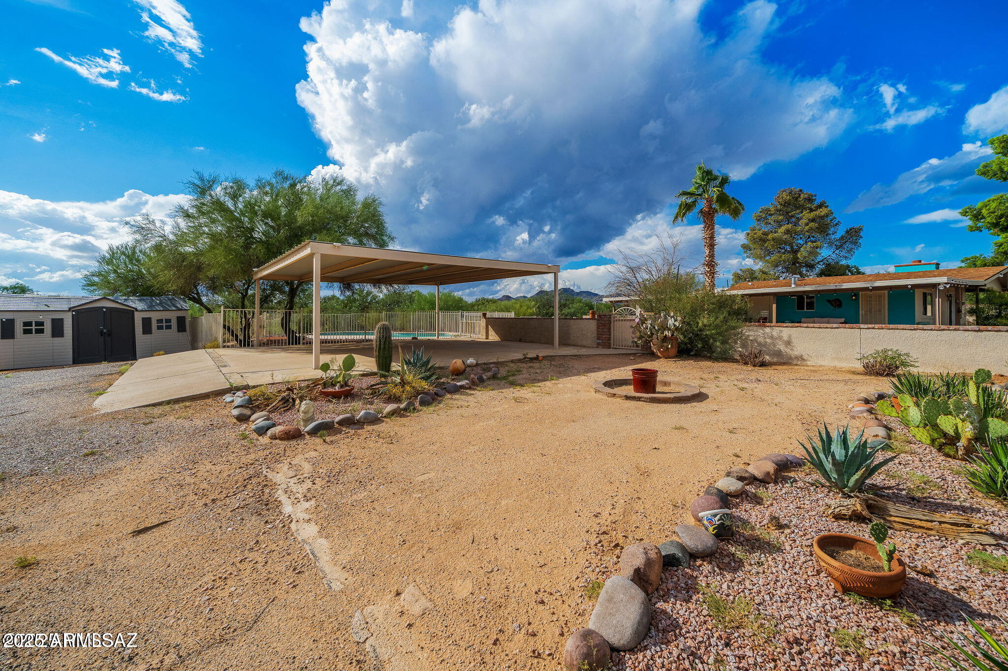 2350 West Sunkist Road Tucson, AZ 85755 - Photo 29 of 39 a view of a swimming pool with lawn chairs under an umbrella