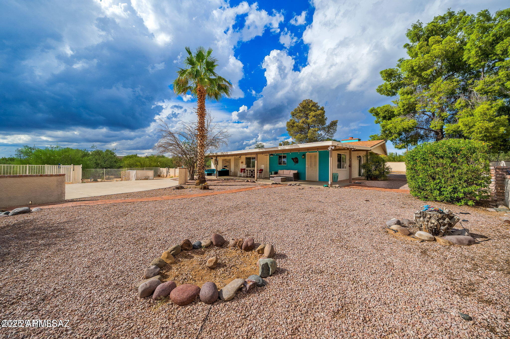 2350 West Sunkist Road Tucson, AZ 85755 - Photo 6 of 39 a front view of a house with a yard and a garage