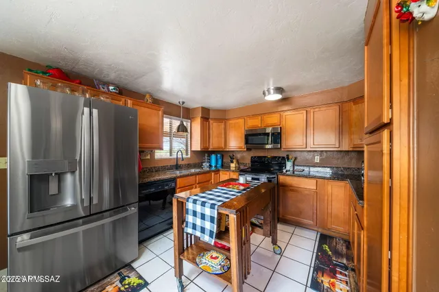 a kitchen with stainless steel appliances a refrigerator and a stove