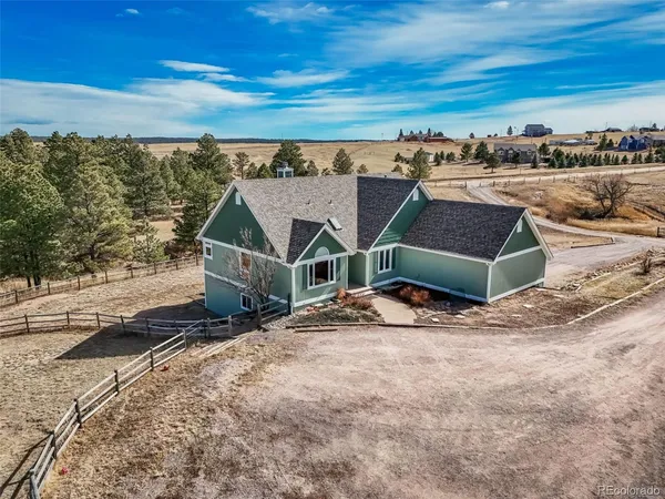 an aerial view of a house with a ocean view