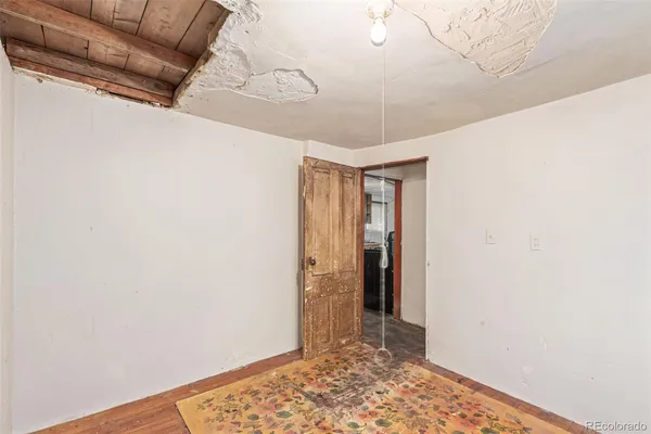 a view of hallway with closet and wooden floor