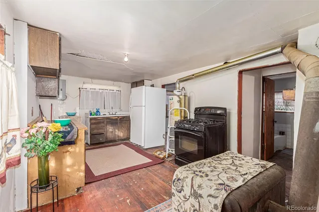 a kitchen with stainless steel appliances kitchen island granite countertop a refrigerator and a stove top oven