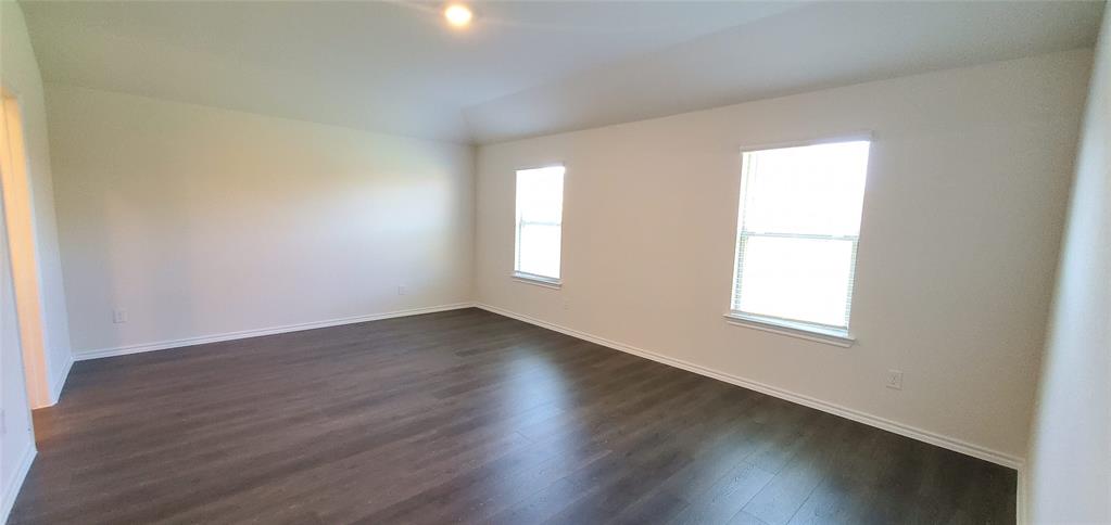 2125 Basil Avenue Anna, TX 75409 - Photo 5 of 12 an empty room with wooden floor and windows