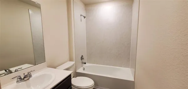 a bathroom with a sink a toilet and bathtub