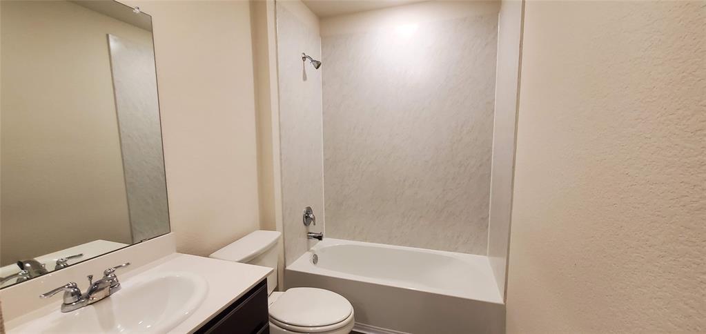 2125 Basil Avenue Anna, TX 75409 - Photo 8 of 12 a bathroom with a sink a toilet and bathtub