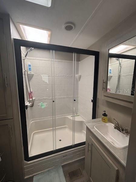 14403 Northeast 252nd Ct Road, Unit 128 Fort McCoy, FL 32134 - Photo 14 of 23 a bathroom with a shower sink and mirror