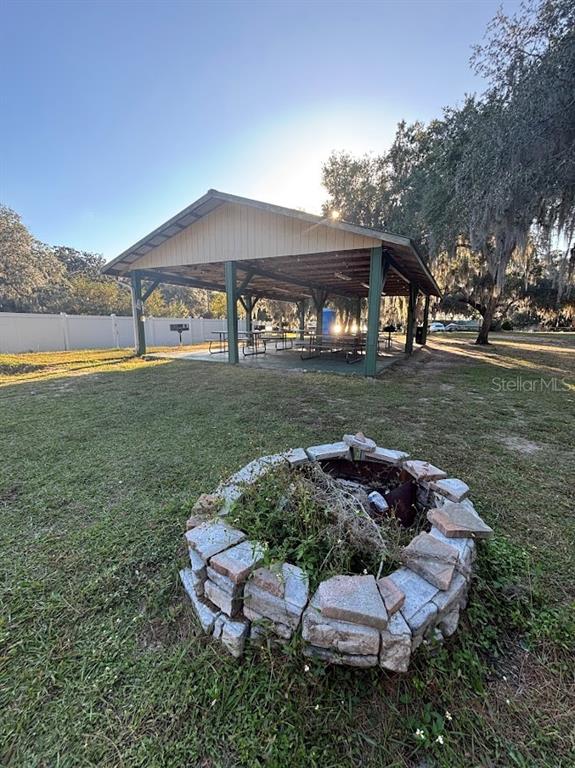 14403 Northeast 252nd Ct Road, Unit 128 Fort McCoy, FL 32134 - Photo 19 of 23 a backyard of a house with a yard and outdoor seating