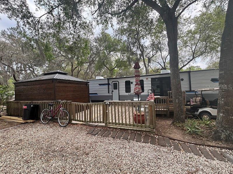 14403 Northeast 252nd Ct Road, Unit 128 Fort McCoy, FL 32134 - Photo 6 of 23 a view of a house with a yard and furniture