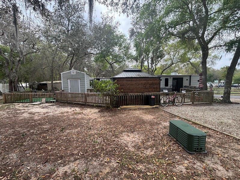 14403 Northeast 252nd Ct Road, Unit 128 Fort McCoy, FL 32134 - Photo 8 of 23 a front view of a house with a yard and sitting area