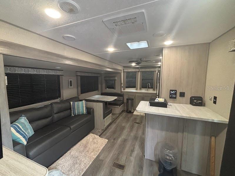 14403 Northeast 252nd Ct Road, Unit 128 Fort McCoy, FL 32134 - Photo 10 of 23 a living room with furniture and a large window