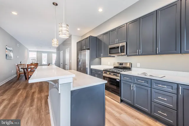 a kitchen with a stove a sink and a refrigerator