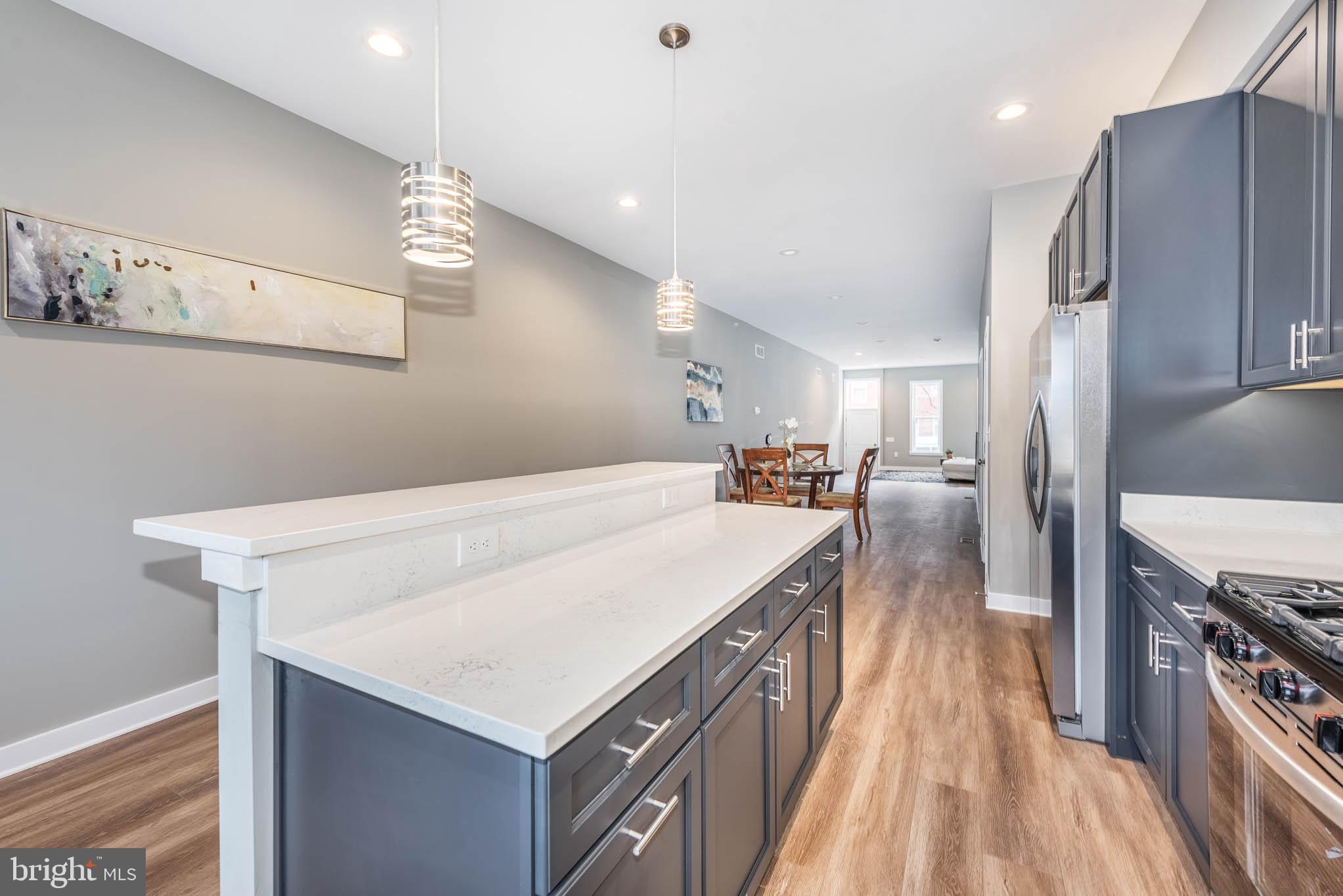 848 Edmondson Avenue Baltimore, MD 21201 - Photo 13 of 41 a large kitchen with a stove a refrigerator and a sink